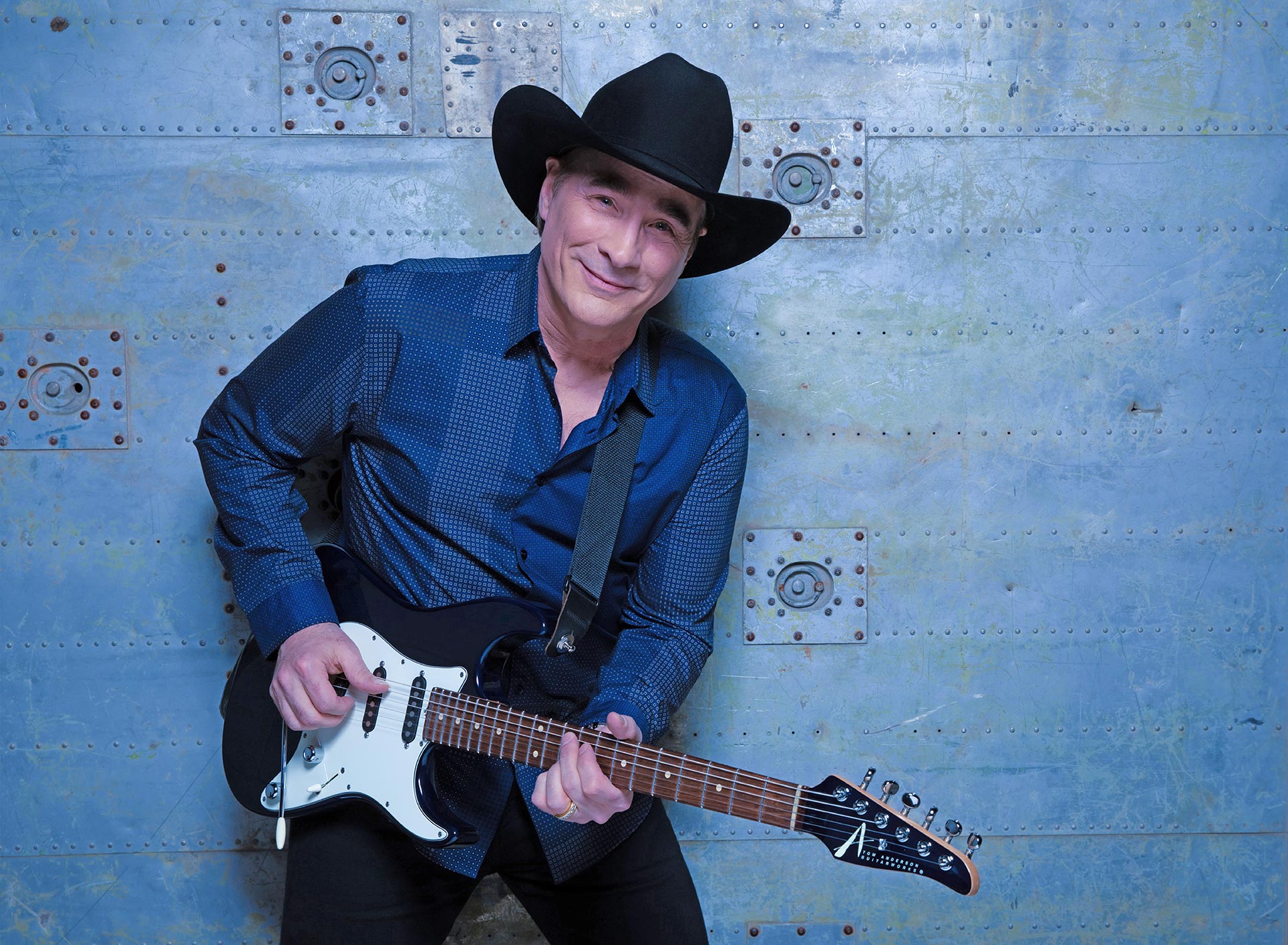 Image: Country singer Clint Black poses for a photograph inside a vintage vehicle.