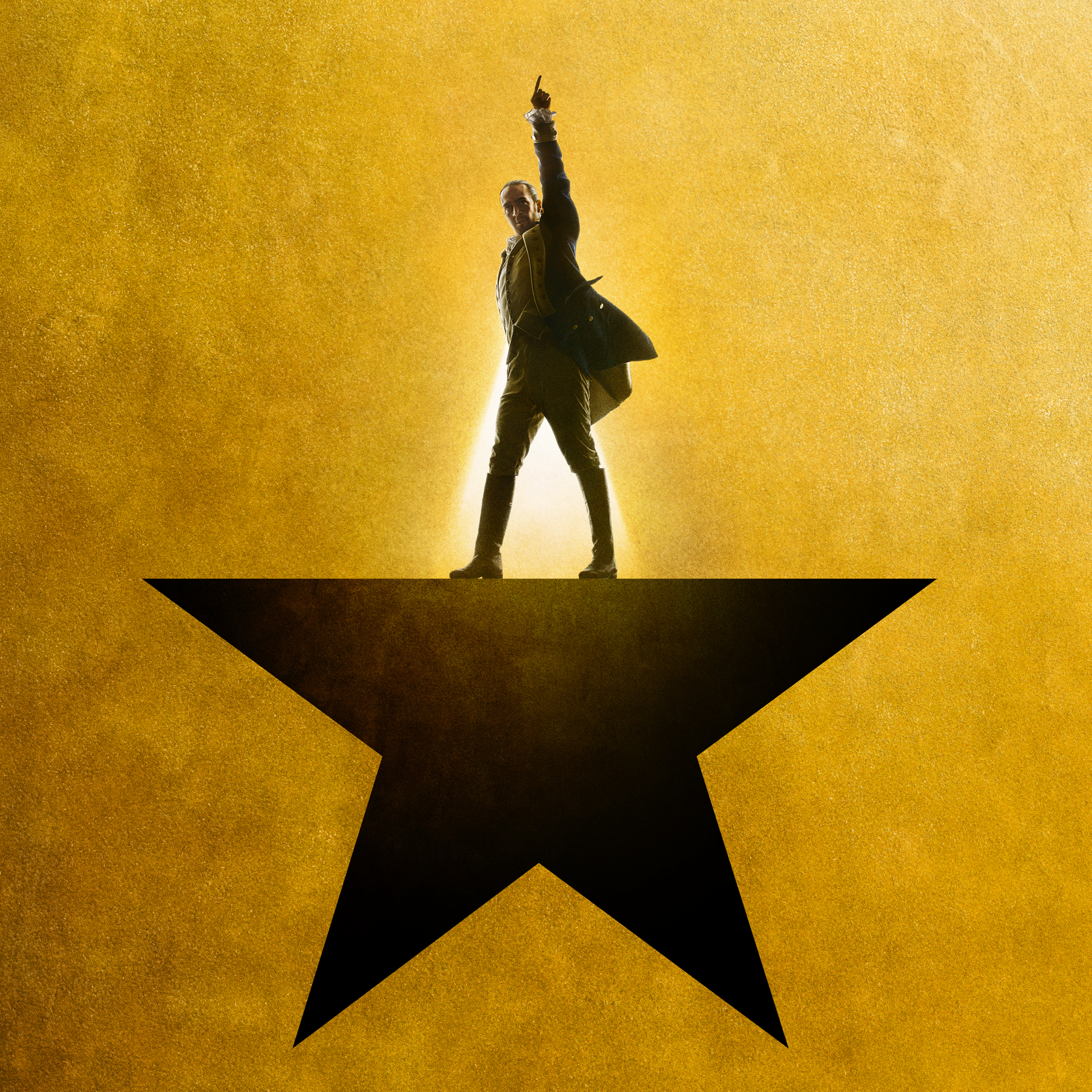 Promotional graphic for the film "Hamilton." A silhouetted man stands atop a star on a gold background.